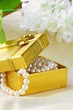 pearl necklace in a gold gift box