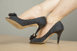 Woman with high heel shoes on desk