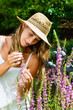 Photo: Woman gardener standing in the garden Woman gardener standing in the garden