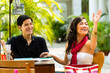 Asian man and woman in restaurant