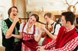 Young people in traditional Bavarian Tracht in restaurant or pub
