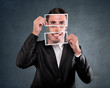 Businessman holding a smile over his face