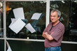 Senior man throwing  clear white papers in the air