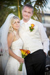 Bride and groom looking at camera.