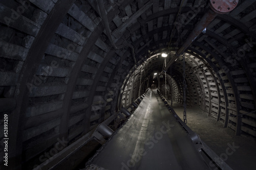 Fototapeta Coal mine machinery: belt conveyor in underground tunnel