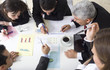 Businesspeople working together at meeting, discussing document
