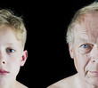 Old man and young boy face comparison closeup