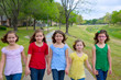 Children group of sisters girls and friends walking in park
