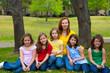 Mother teacher with daughter pupils in playground park