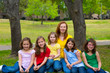Mother teacher with daughter pupils in playground park