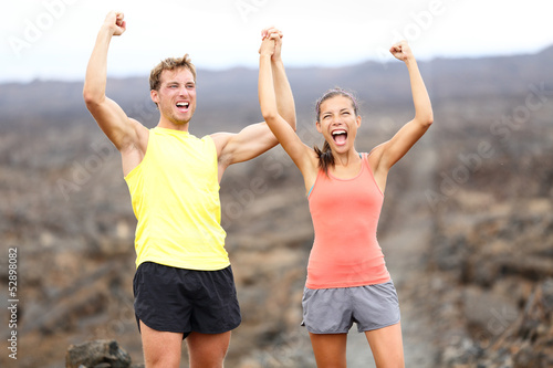Photo: Cheering celebrating happy fitness runner couple Cheering celebrating happy fitness runner couple