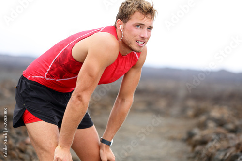 Photo: Runner man resting with music after running Runner man resting with music after running