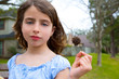girl portrait with sweetgum spiked fruit on park