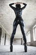 Sexy fetish model posing in old industrial building