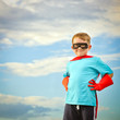 Child pretending to be a superhero with copy space