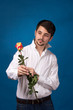 young man giving a red rose