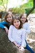 friend sister girls resting on tree trunk nature