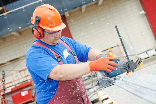 Photo: Builder worker at construction site Builder worker at construction site