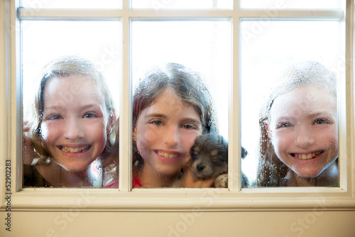 Photo: three sister friends looking through the rainy window three sister friends looking through the rainy window