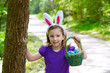 Photo: Easter girl with eggs basket and funny bunny ears Easter girl with eggs basket and funny bunny ears