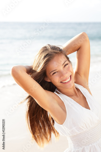 Photo: Beautiful young woman girl relaxing on beach Beautiful young woman girl relaxing on beach