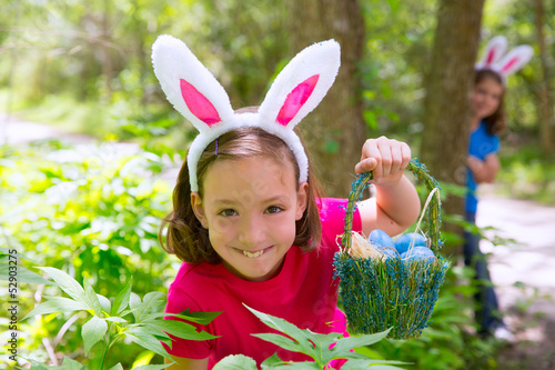 Photo: Easter girl with eggs basket and funny bunny face Easter girl with eggs basket and funny bunny face