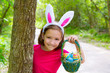 Photo: Easter girl with eggs basket and funny bunny face Easter girl with eggs basket and funny bunny face