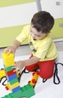 Little boy who builds castles with plastic cubes