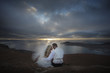 Newlyweds observing sunset in Canary Islands.
