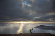 Newlyweds observing sunset near the ocean shore in Canary's.