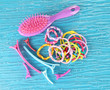 Scrunchies, hairbrush  and  hair - clip   on a blue background
