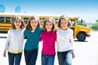 school girls friends in a row walking from school bus