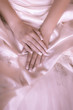 Foto: bride's hands on a white wedding dress bride's hands on a white wedding dress