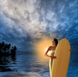 Young woman on the beach at sunset
