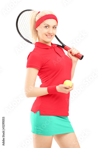 Photo: Smiling female holding a tennis racket and a ball Smiling female holding a tennis racket and a ball