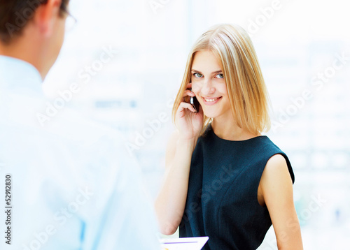 Photo: Two young business collegues. Two young business collegues.