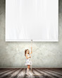 Photo: Little girl pulling banner Little girl pulling banner