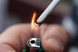 Closeup of a man's hand lights a cigarette with lither