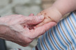 hands of baby grandson and old grandmother, concept of family re