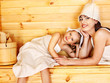 Family with child relaxing at sauna.
