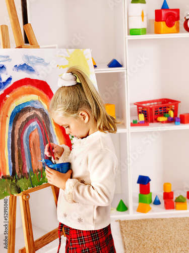 Photo: Child drawing on the easel. Child drawing on the easel.
