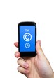 Copyright, trademark symbols  on smart phone. Security and pirac
