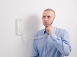 Caucasian man holding an intercom