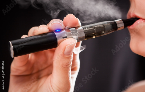 Photo: Woman smoking with electronic cigarette Woman smoking with electronic cigarette