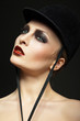 Fashion horsewoman wearing black hat