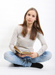 Young woman with book on white background