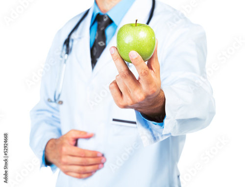 Photo: Doctor's hand holding a fresh green apple close-up Doctor's hand holding a fresh green apple close-up