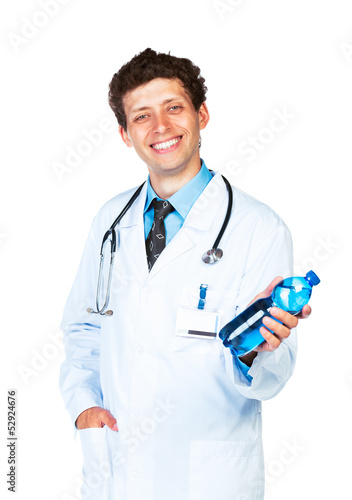 Photo: Smiling doctor holding bottle of water on white Smiling doctor holding bottle of water on white