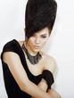 Sentiment. Bright Woman with Black Updo Hair and Necklace