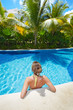 Photo: Woman in swimming pool at caribbean resort. Woman in swimming pool at caribbean resort.